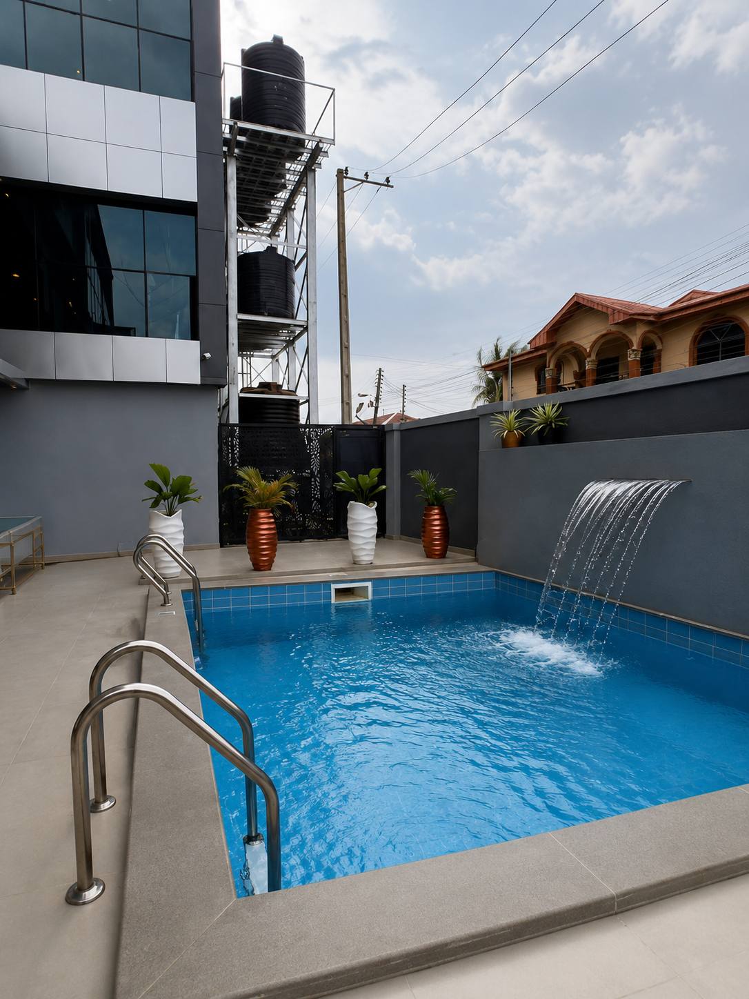 The outdoor swimming pool with waterfall feature at GAIA HOTELS & SUITES