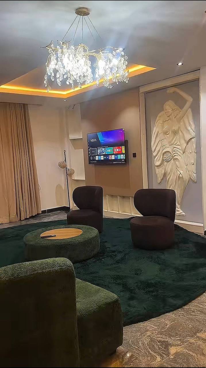Suite living area with chandelier at GAIA HOTELS & SUITES
